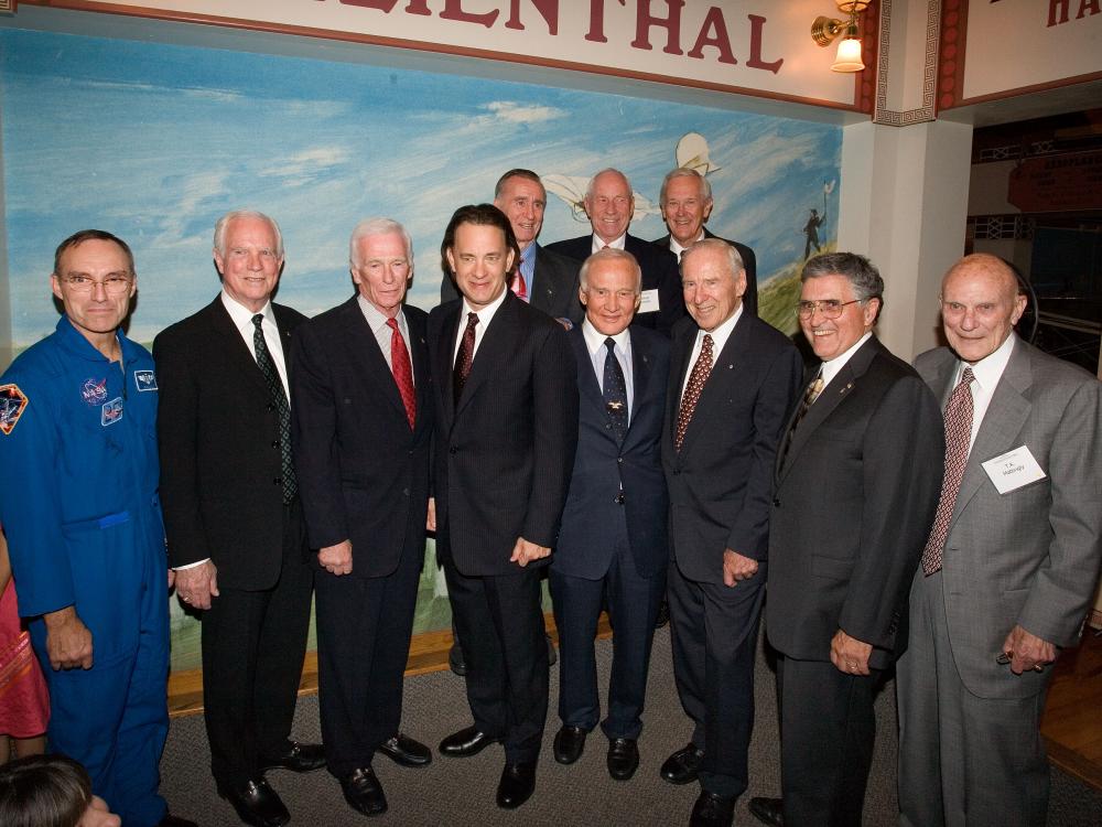 Group of men dressed in suits for an event pose for a photograph inside the Museum.