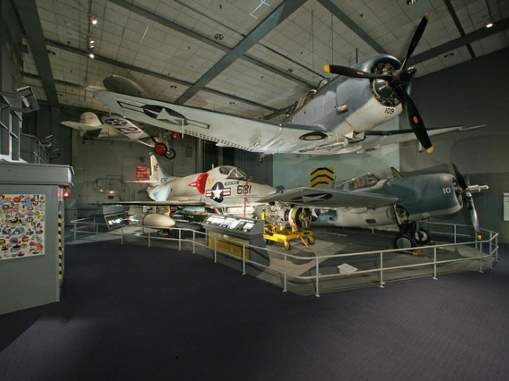 Planes are suspended in the air and sit on the floor in the Sea-Air Operations gallery.