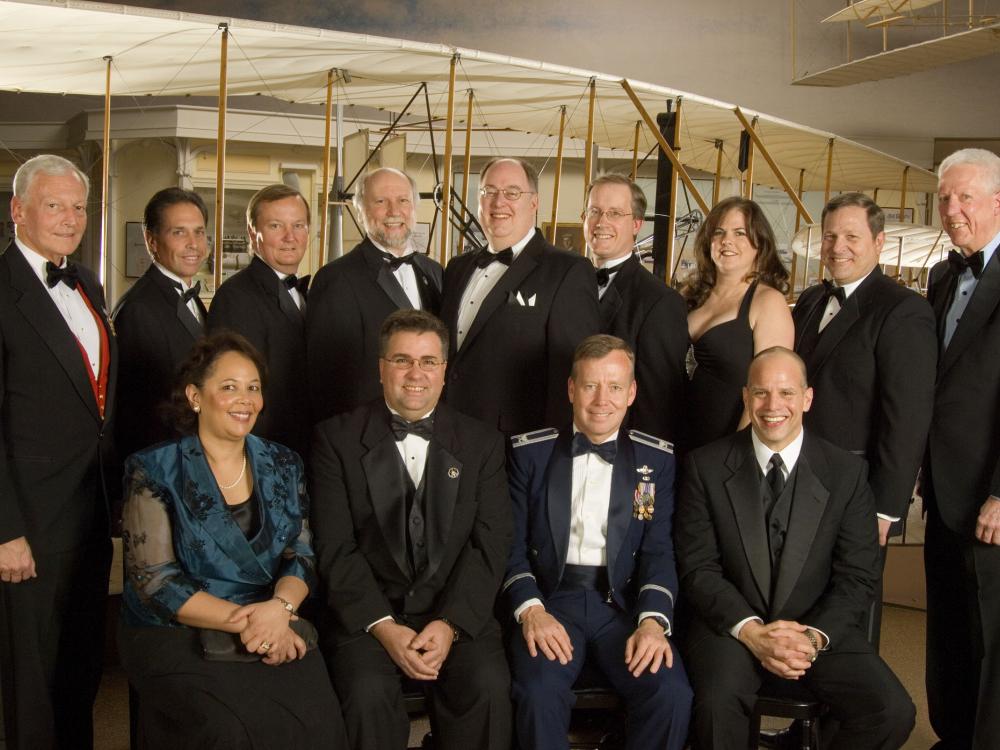 Former Museum Director Jack Dailey, Awards Master of Ceremonies David Hartman, N. Wayne Hale, Jr., and members of the STS-121 team stand together for a group photo at an awards ceremony.