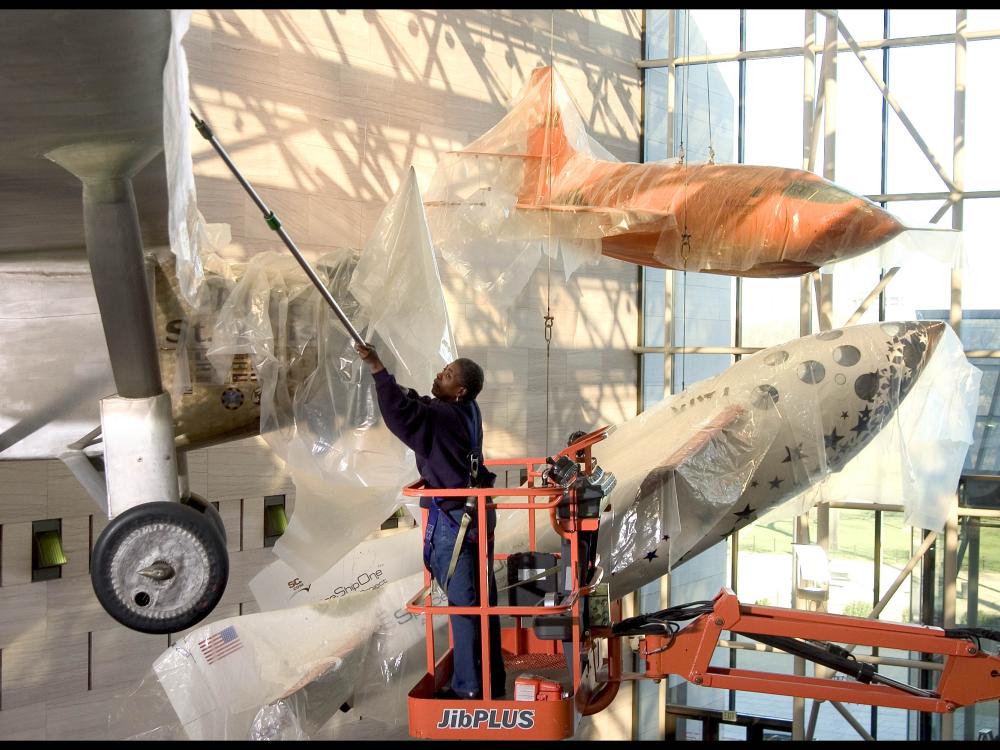 Brenda Averett protecting aircraft in the Boeing Milestones of Flight Hall