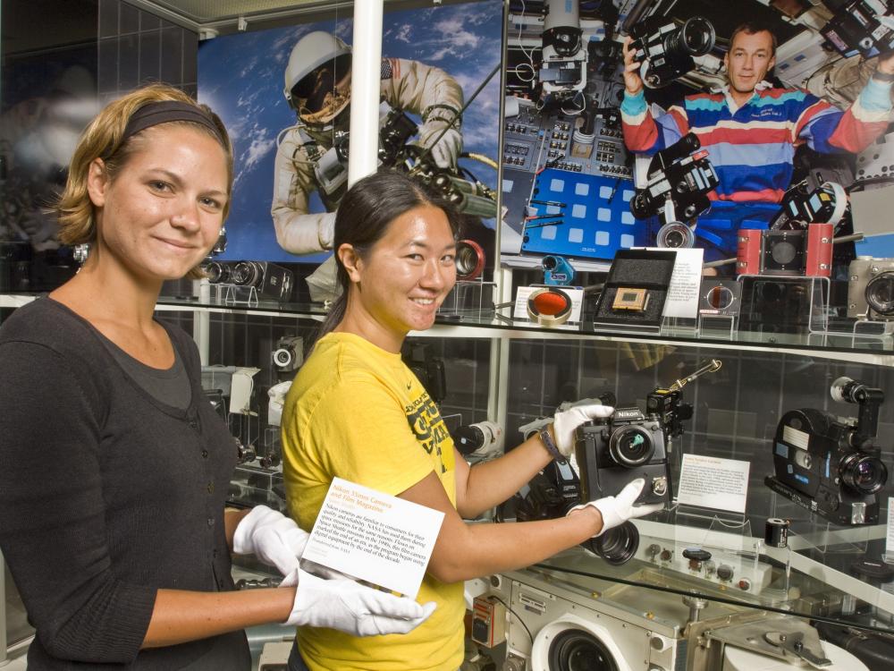 Museum Specialist installing the Space Camera Exhibit Case