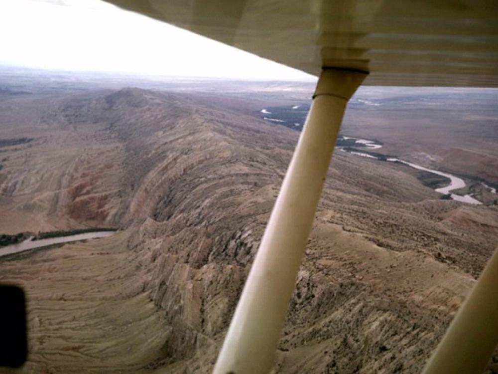 View of a mountain and valley from an airplane.