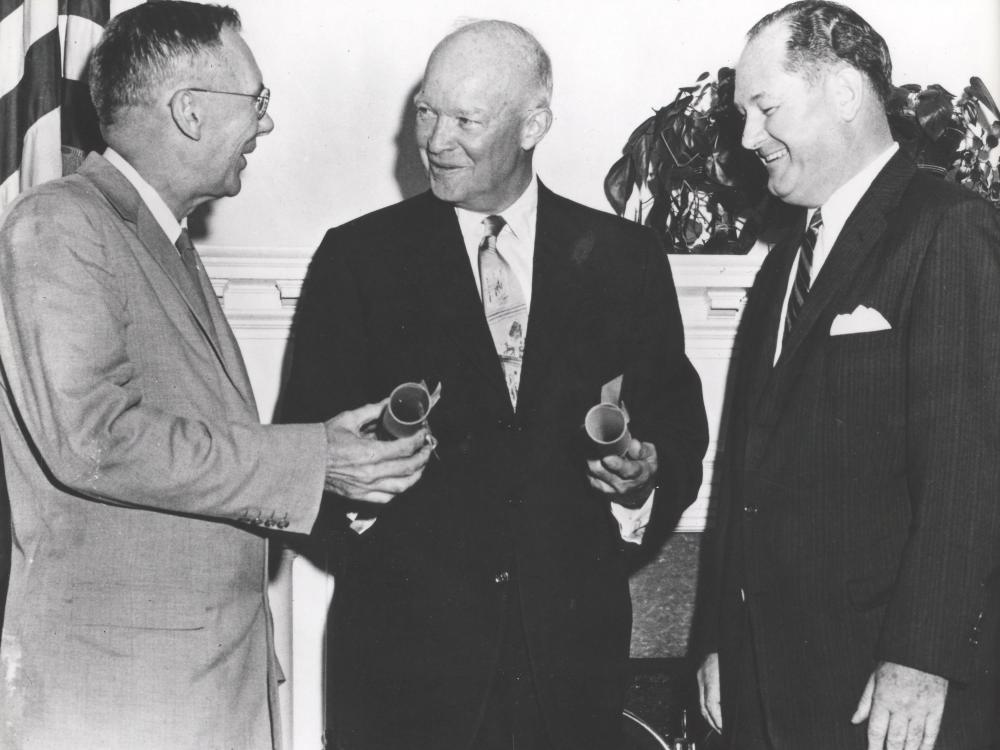 President Eisenhower stands next to Dr. T Keith Glennan and Hugh L. Dryden.