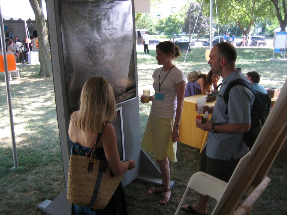 A woman stands at the Folklife Festival among festival patrons.