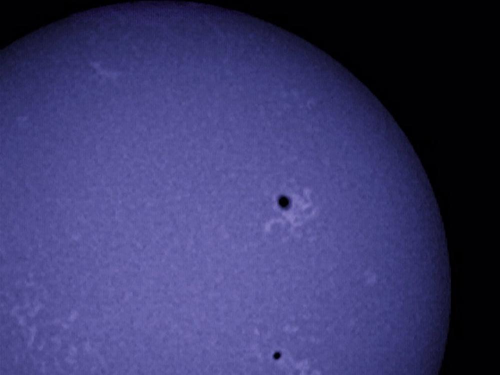 View of the chromosphere of the sun with an emphasis on multiple sunspots.