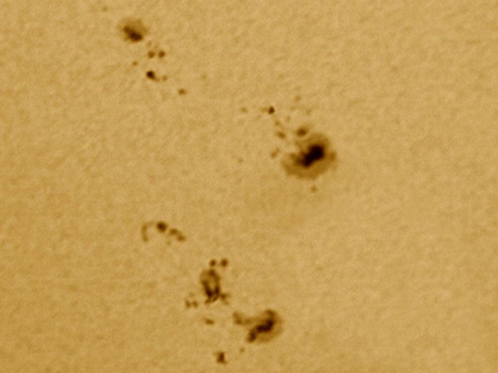 A close-up view of two groups of sunspots on the Sun.