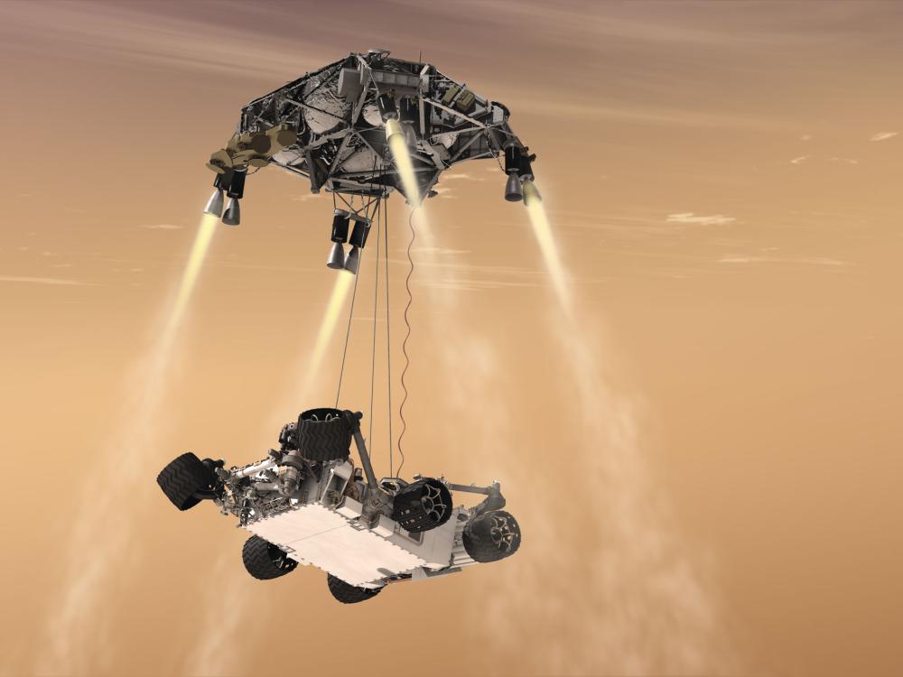 Artist depiction of Curiosity, a robotic Mars rover, in the process of landing on Mars using part of its body with propellors to facilitate a safe landing.