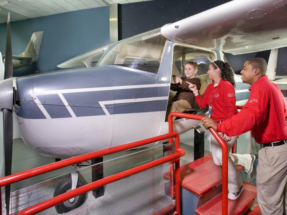 Explainers Assist a Young Visitor in the How Things Fly