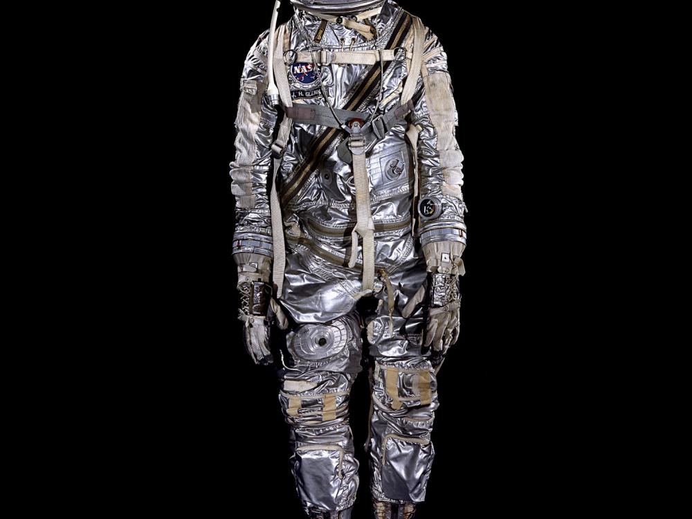 Spacesuit made of aluminized fabric with boots, gloves, and helmet on mannequin