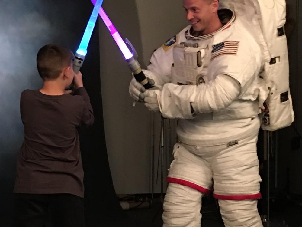 Nick Hague, class of 2013 astronaut, tweeted this photo of himself being “ambushed” by his son during an official NASA photo shoot