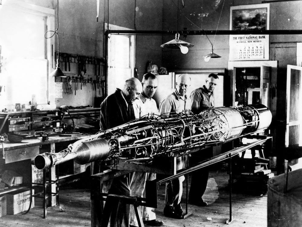 Robert Goddard works on a rocket with his team. 