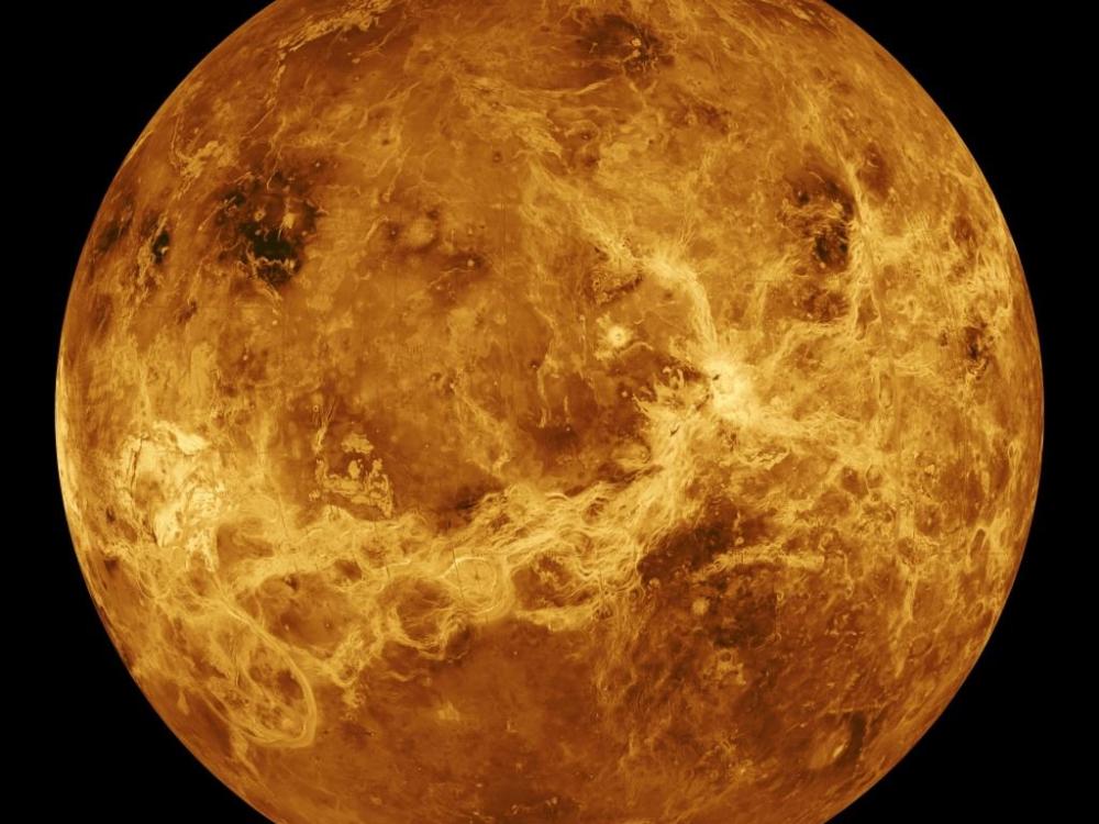 Disk image of Venus, a orangeish-brown rocky planet.