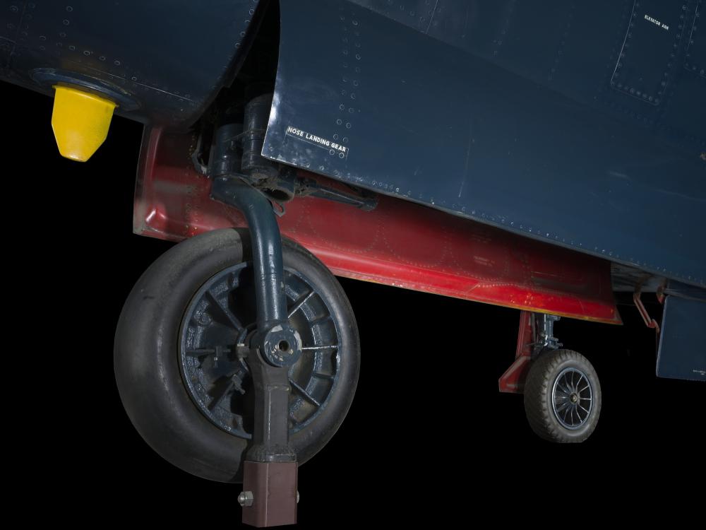 Larger wheel and smaller wheel with landing gear of blue McDonnell FH-1 Phantom I aircraft