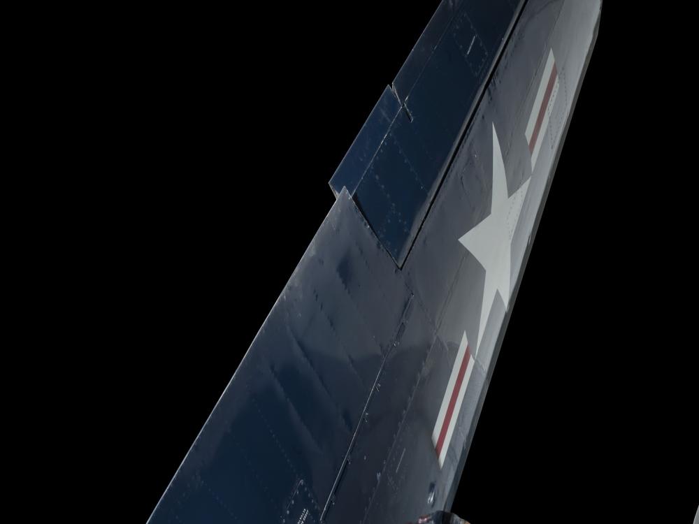 Upright folded wing of blue McDonnell FH-1 Phantom I aircraft with United States Air Force insignia