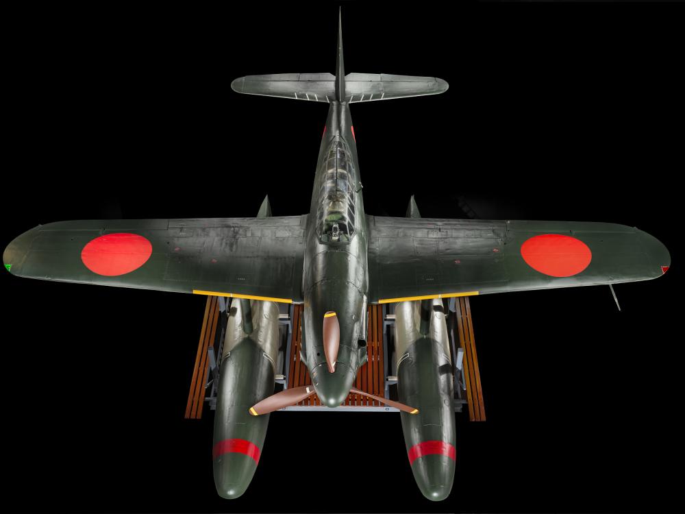 View from top of green bomber with red roundels on the wings and twin floats in place of wheels