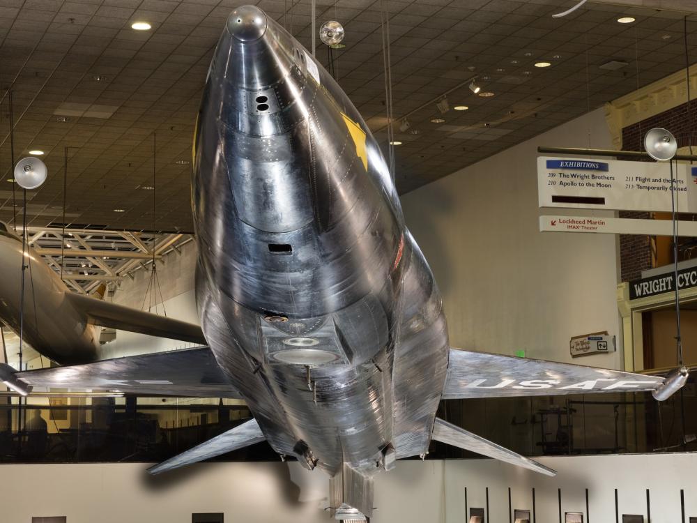 Tip of black titanium rocket-shaped North American x-15 aircraft hanging in museum