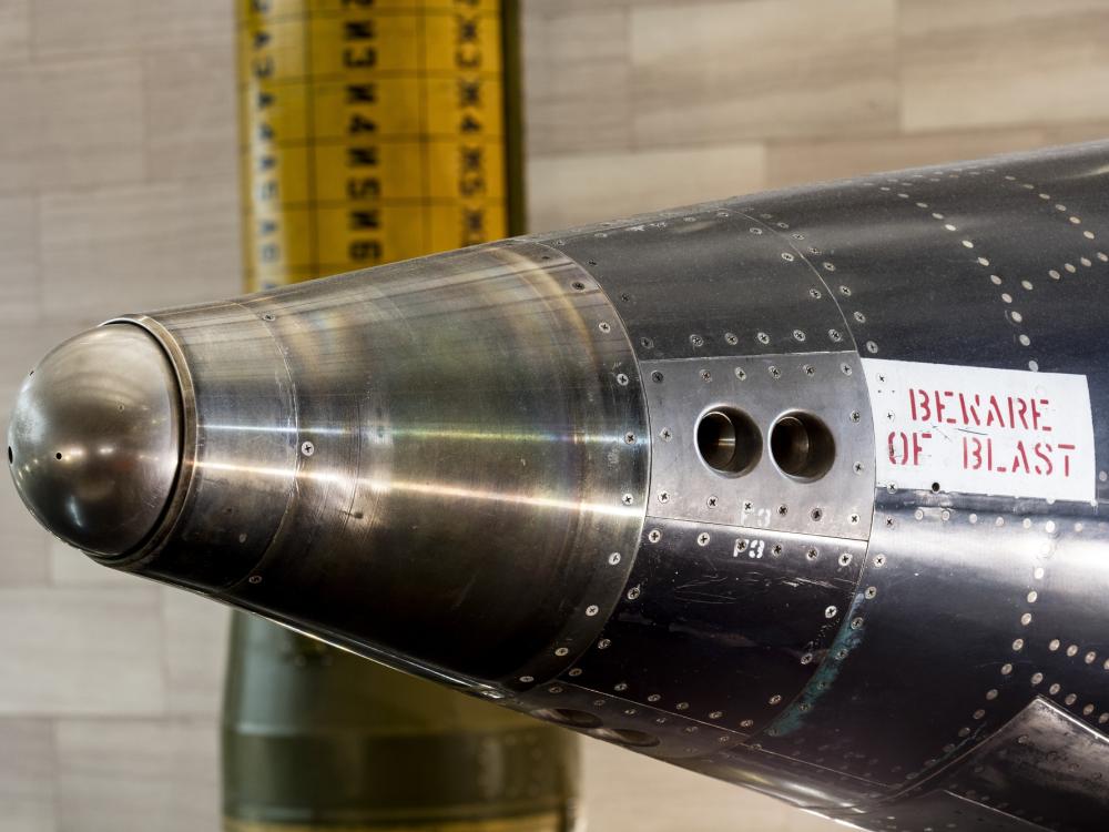 Two circlular indentations on side of rounded nose of black titanium North American x-15 aircraft