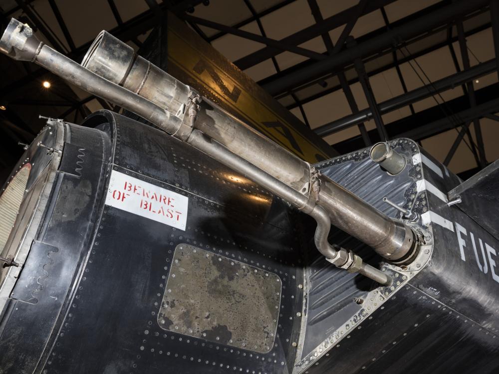 Two narrow tail pipes on back side of black titanium North American X-15 aircraft