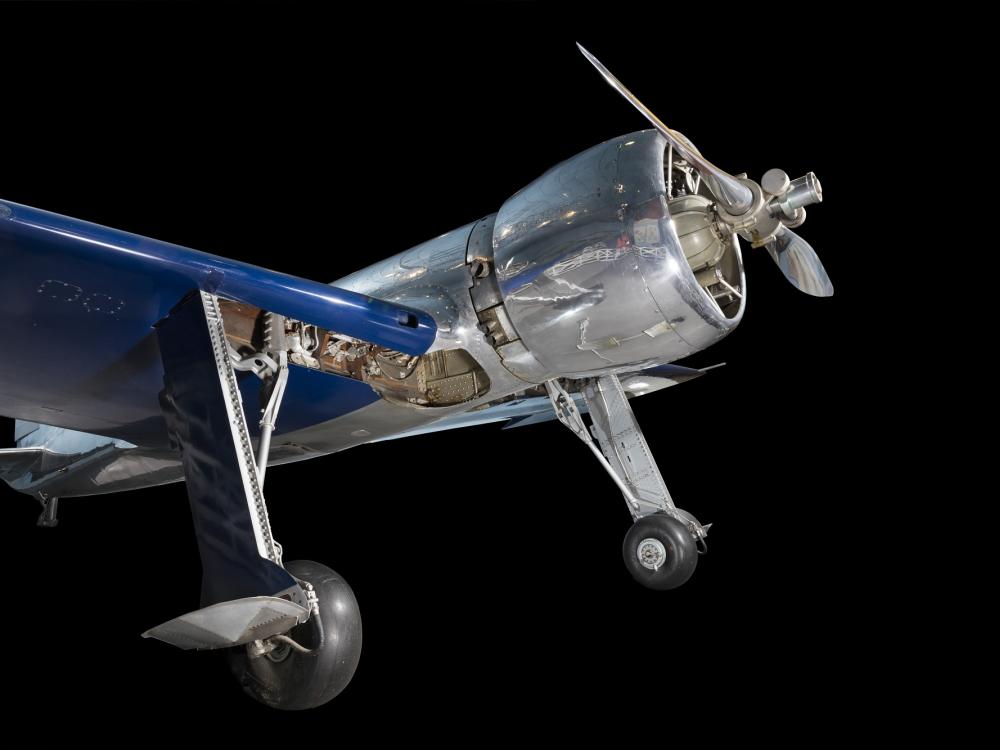 Front of metalic silver and blue Hughes H-1 Racer aircraft with propeller and engine