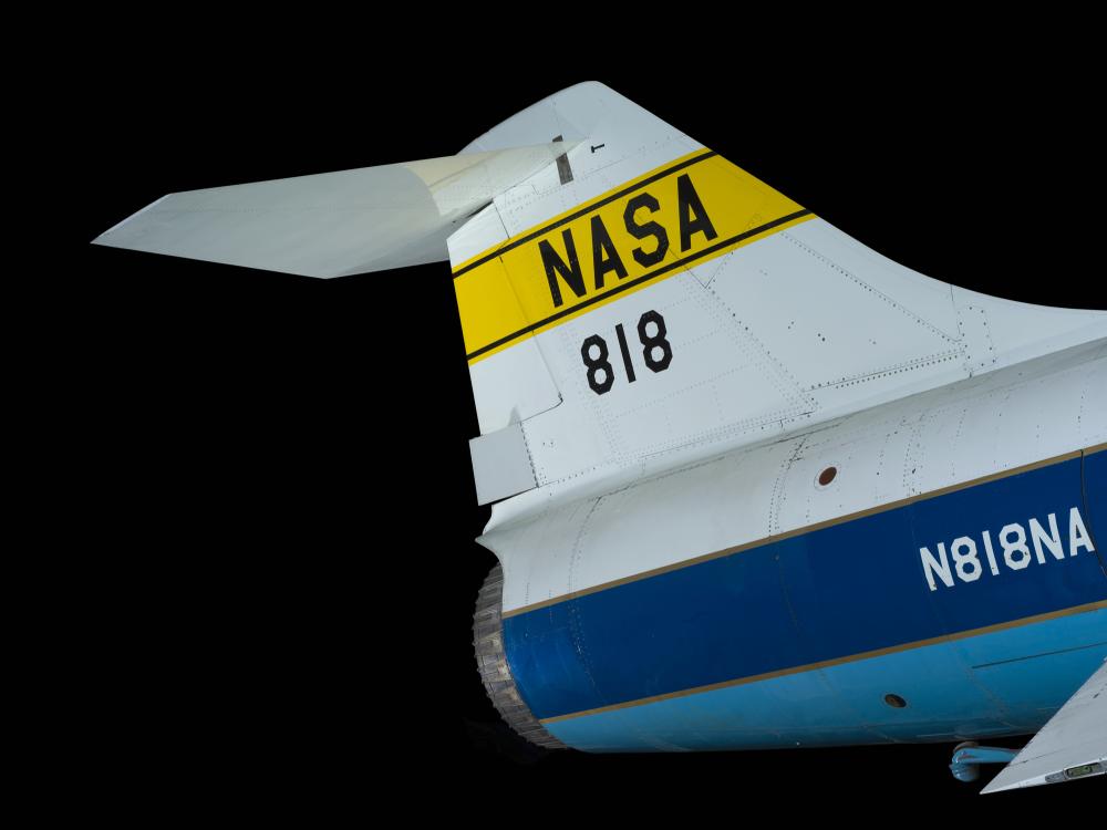 Tail of Lockheed F-104A Starfighter aircraft with "NASA" on yellow stripe in black lettering and "818"