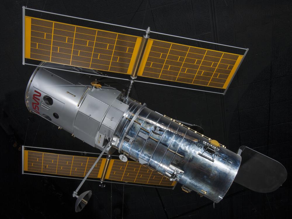 Side view of metal Hubble Space Telescope Model with yellow solar panels