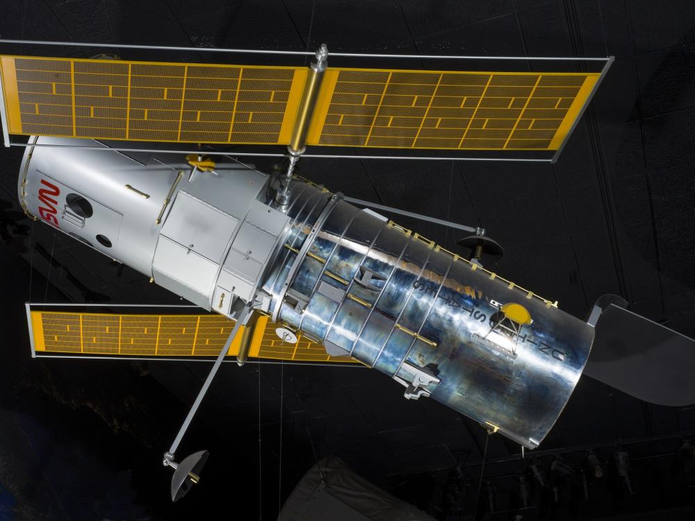 Side view of metal Hubble Space Telescope Model hanging in museum