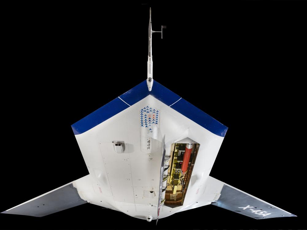 Bottom view of flat white and blue Boeing X-45A with missile bay opened