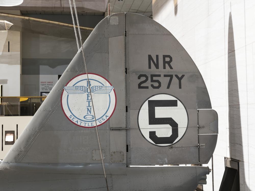 Boeing logo and "NR257Y" with "5" in white circle on vertical stabilizer on gray Boeing 247-D aircraft