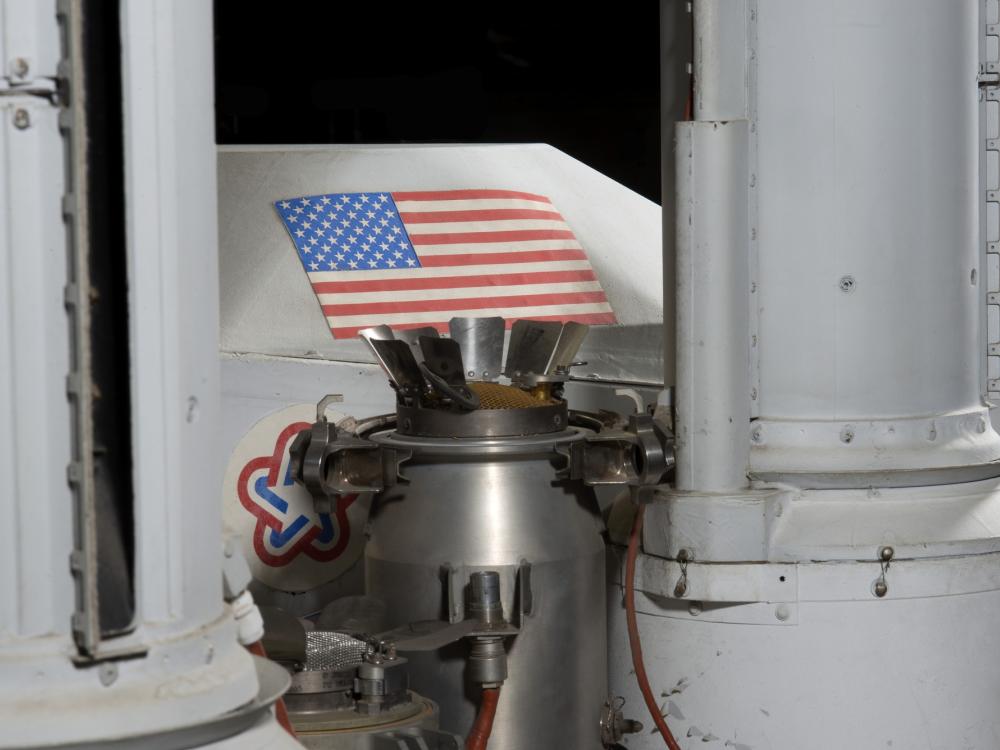 Gas chromatography?mass spectrometry (GCMS) metal part of Viking Mars Lander with American flag sticker in background part of vehicle