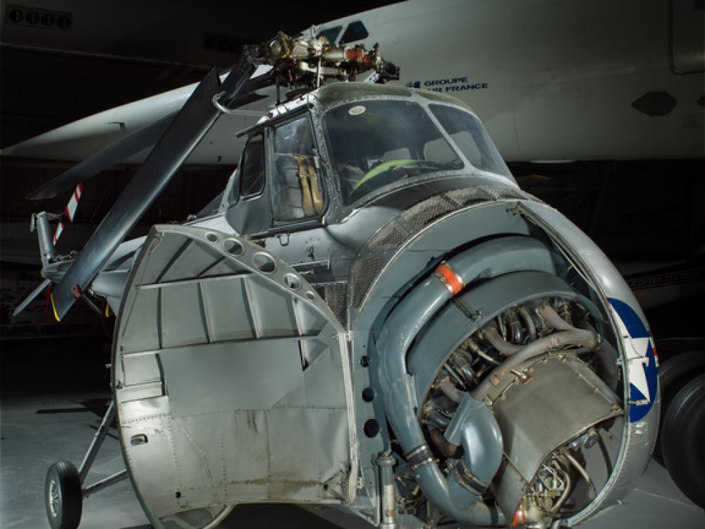 View of a helicopter with a half open nose.