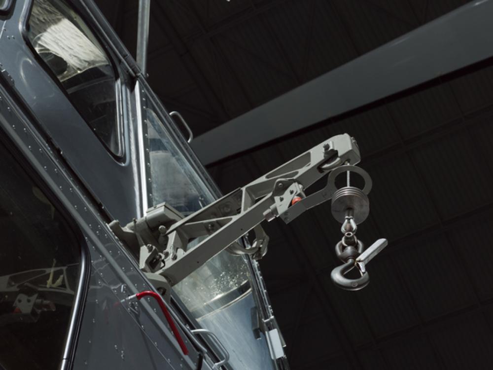 View of a cargo hook attached to a helicopter.