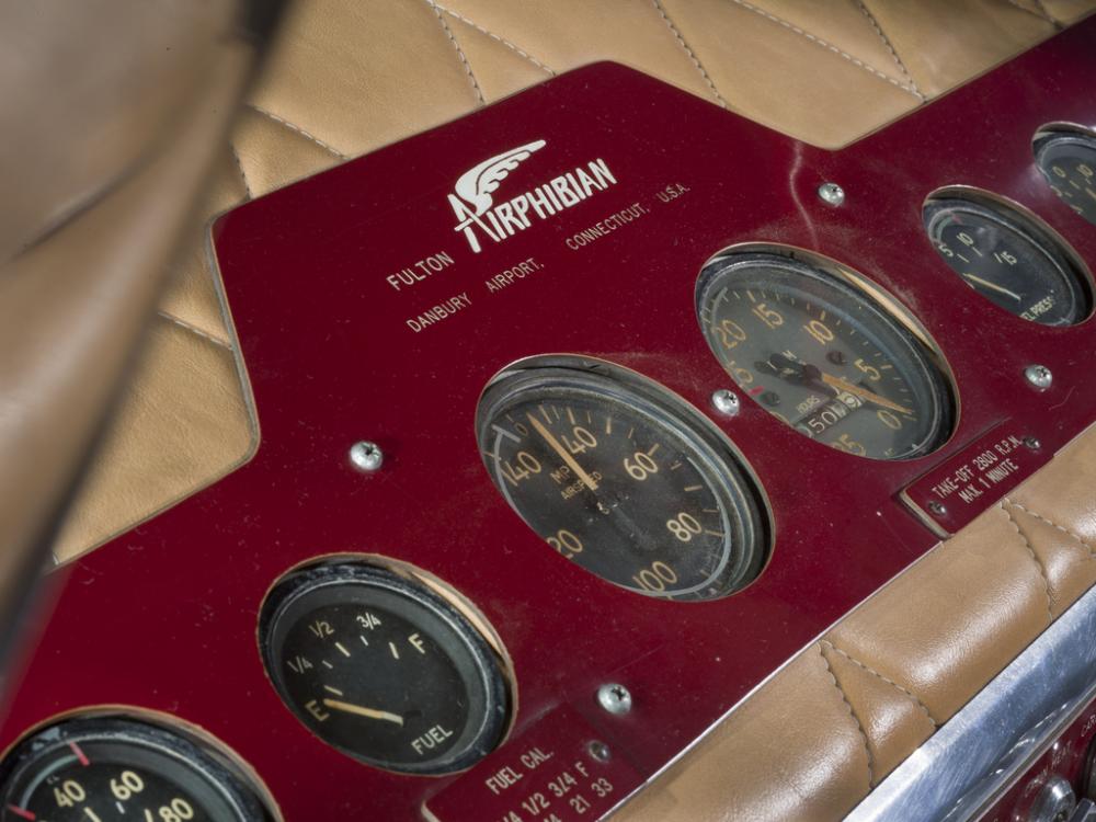 Close up view of the instrument panel of a airplane. The panel display fuel level, miles per hour, and other panels.