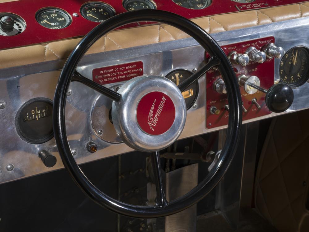 View of a steering wheel connected to an instrument panel on a plane.