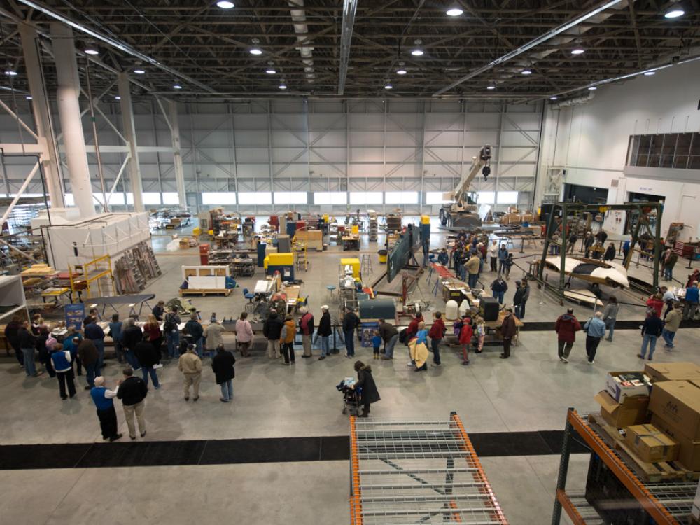 Second-floor view of Museum visitors touring the Museum's restoration hangar during an open house event.