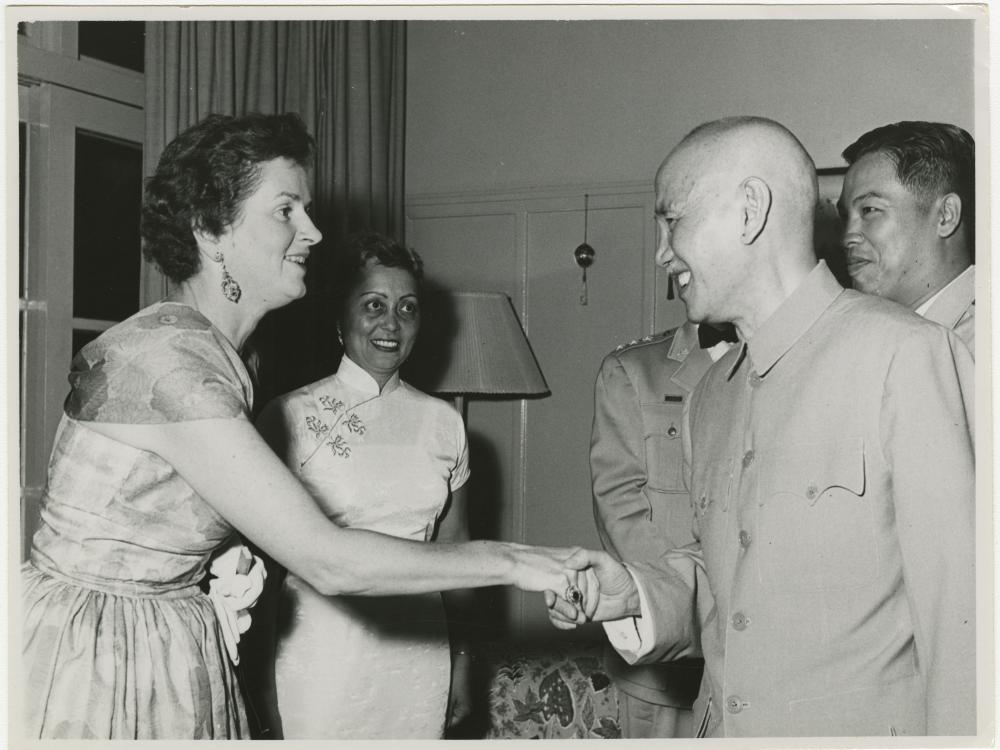 Agatha Davis watches Chiang Kai-Shek shake a woman's hand