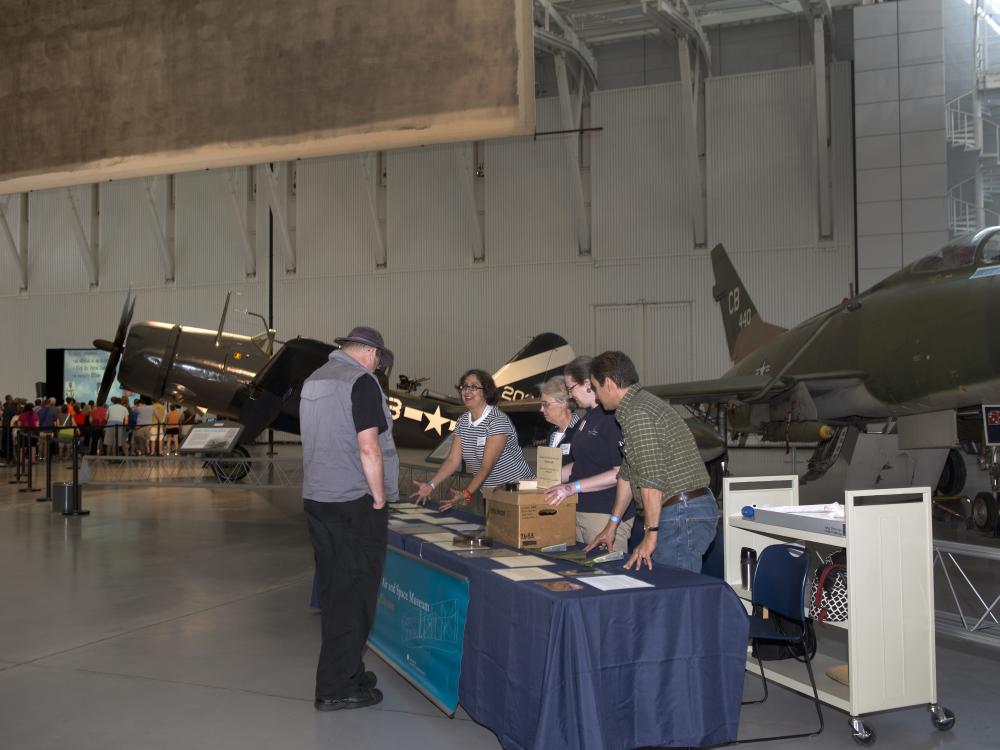 A photo of museum archivists present materials at a 2014 Family Day.