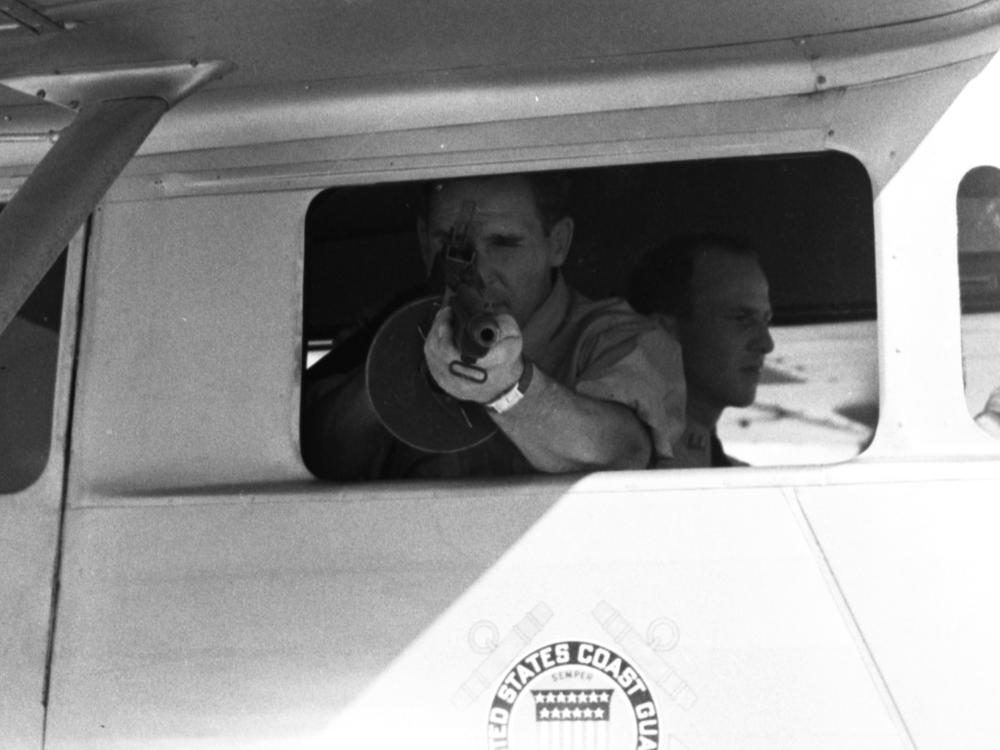 A photo of a Coast Guardsman during a demonstration on handling drug smuggling.