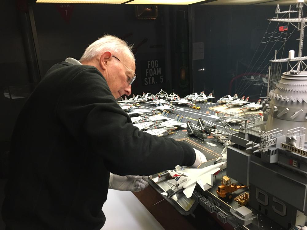 Steve Henninger removes the aft starboard elevator to better access the hangar deck during installation of the LED lights in 2016