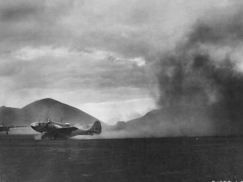 A U.S.-built Martin 167 kicks up dust during takeoff on Ascension Island