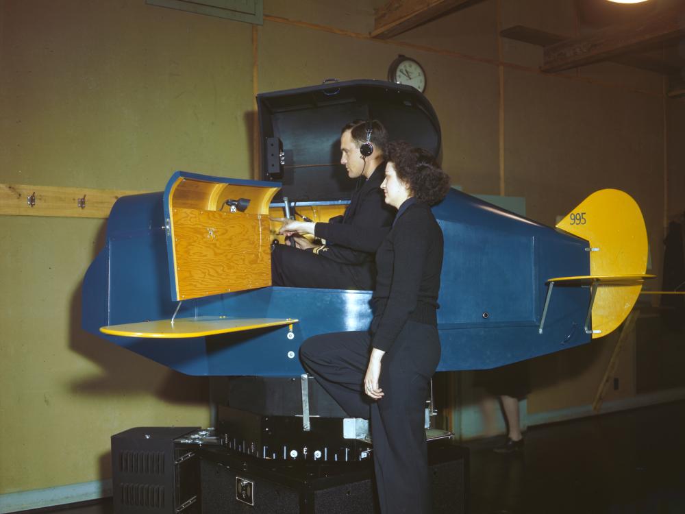 A WAVES Link Trainer instructor gives pointers to an officer