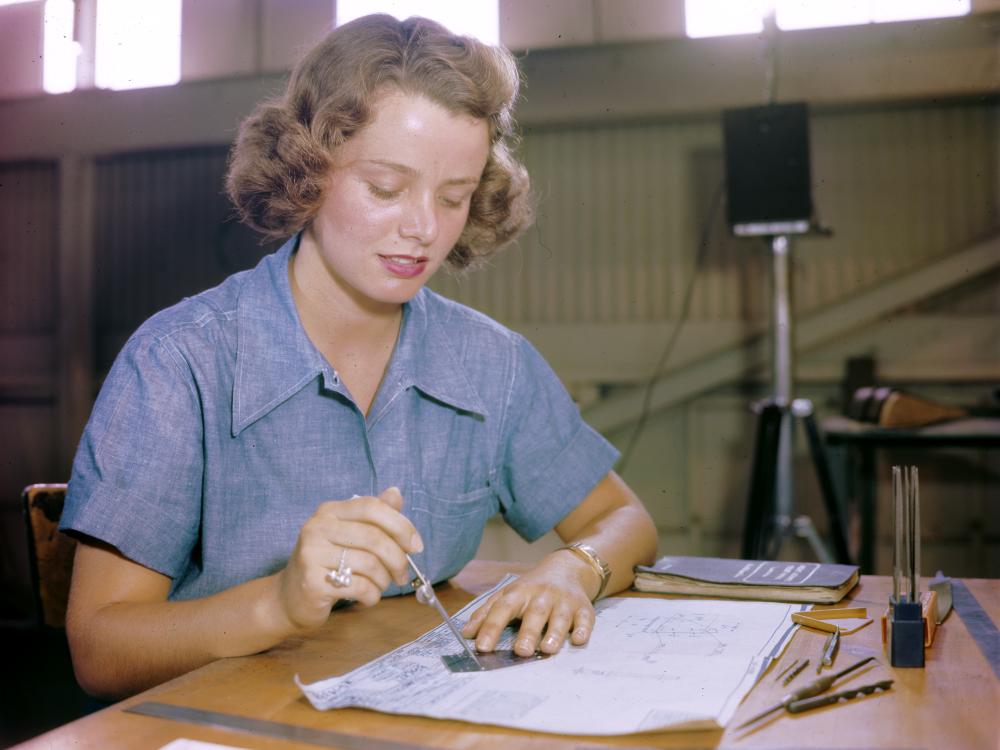 Elizabeth Holbrook and many other WAVES work in a huge assembly and repair building at a Naval Air Station in Hawaii