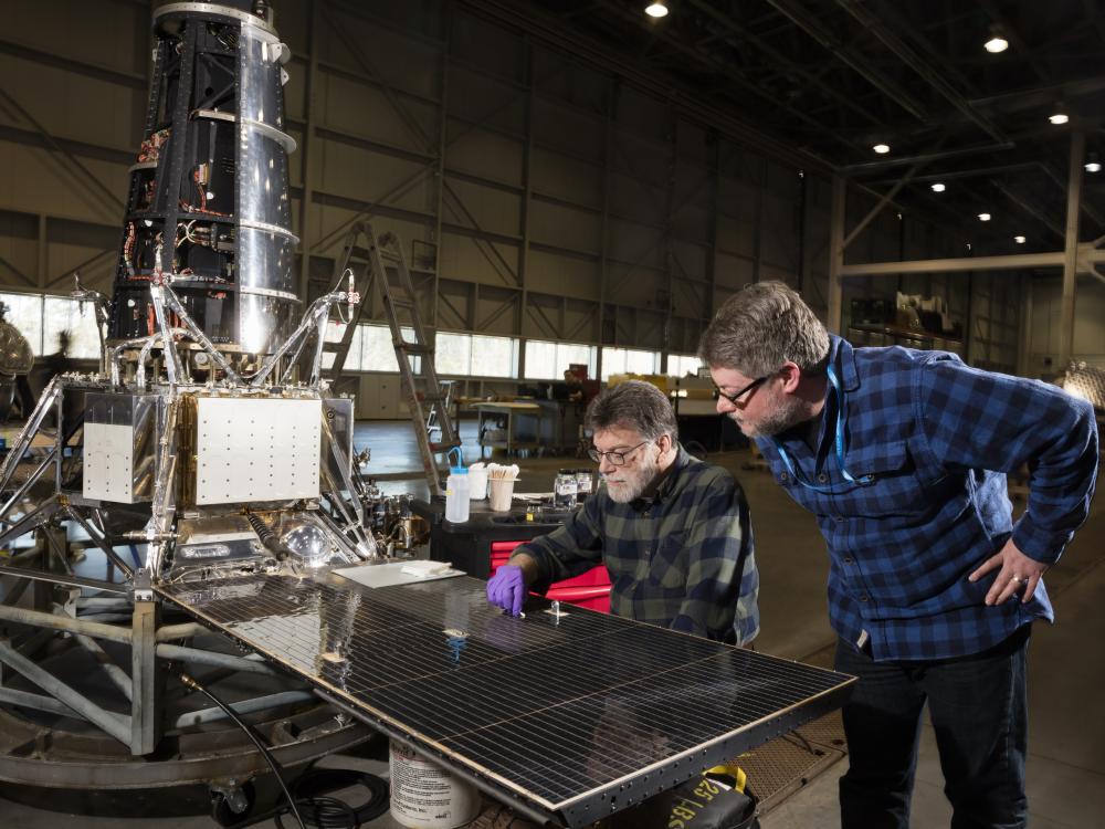 Museum conservator David Blanchfield and space history curator Matt Shindell examining the Ranger 7 spacecraft