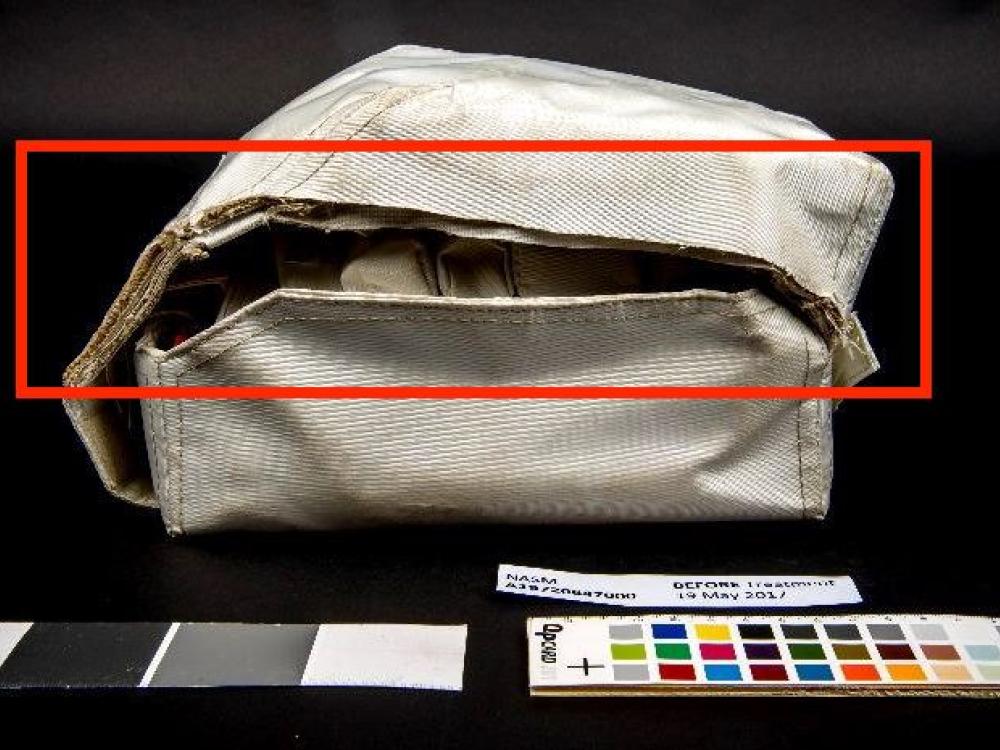 Before conservation, a section of the container’s lid is missing on the left side of the medical kit (indicated in red).