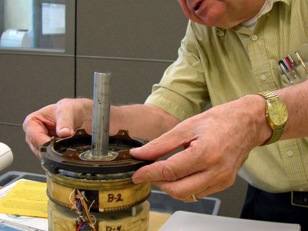 George Ludwig fitting his cosmic-ray detector with the Museum's Explorer 1 satellite.