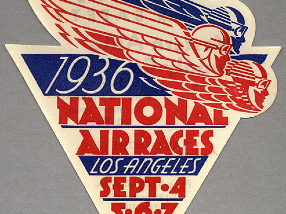 Small sticker in red and blue. Shaped like a triangle and includes the text 1936 National Air Races Los Angles Sept. 4, 5, 6, and 7. 