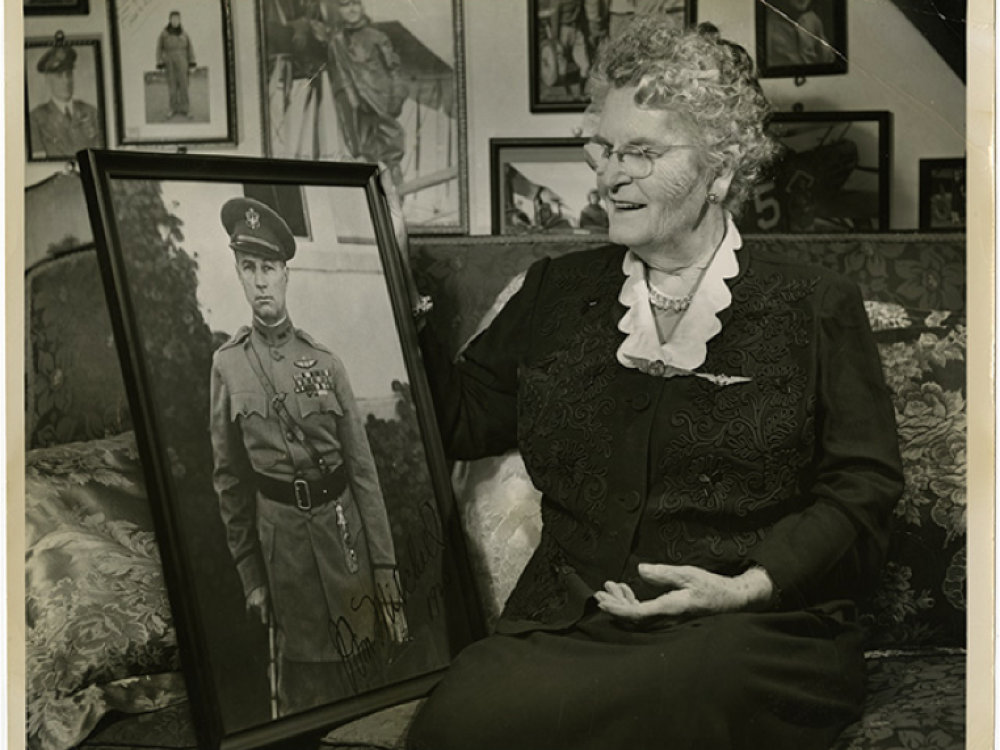 Mother Tusch sitting on a couch at her home