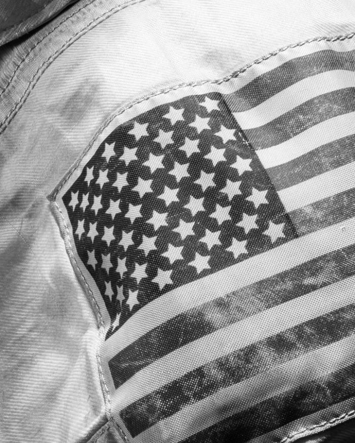 The American flag patch on the arm of a space suit.