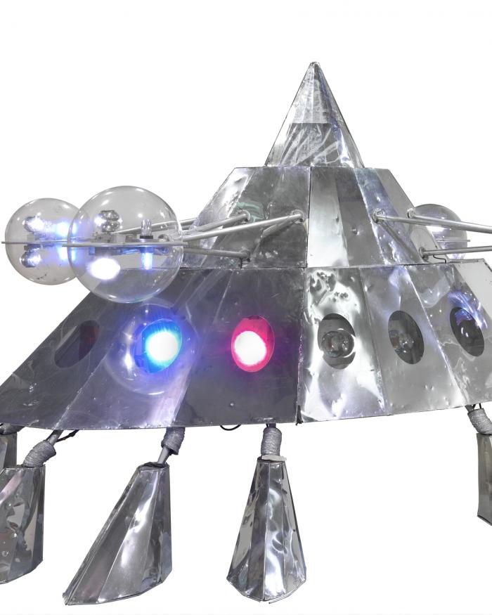 A silver spaceship on seven feet.