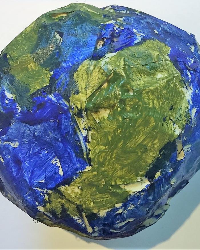 A model of the Earth made of a crumpled paper ball and painted. 