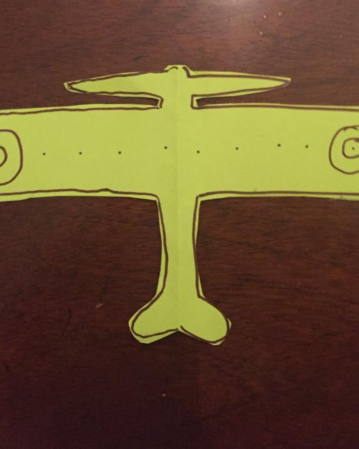 A card shaped like an airplane. 